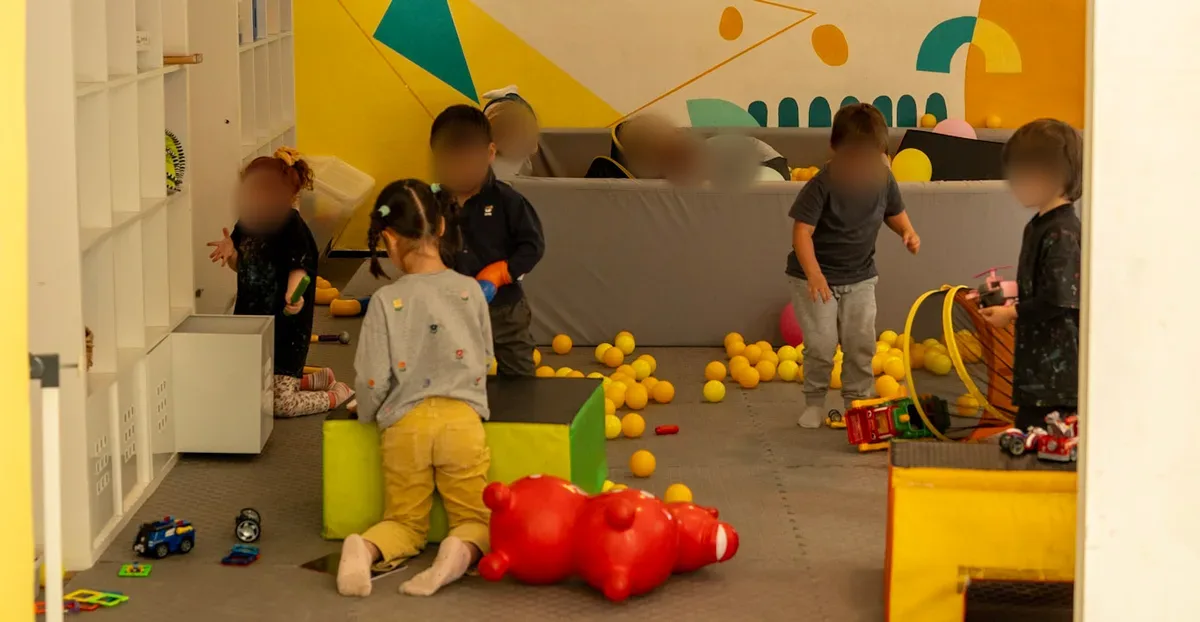 Toddlers playing with balls and toys in the indoor play area at WOW Family Center