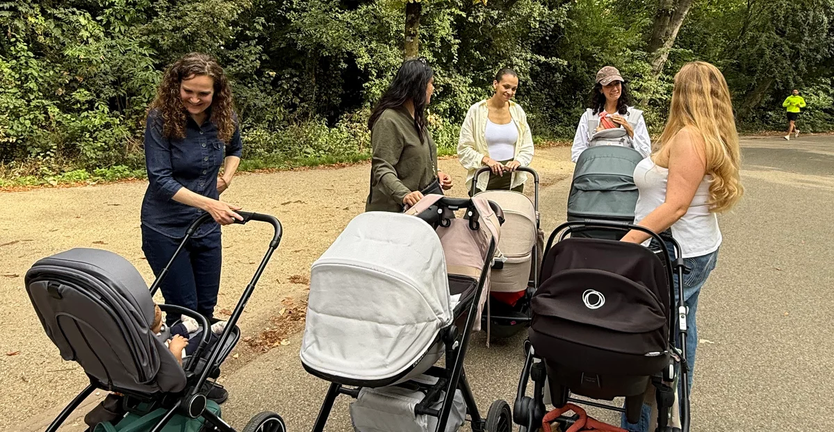 Moms chatting with their babies in strollers during an August walk in Vondelpark